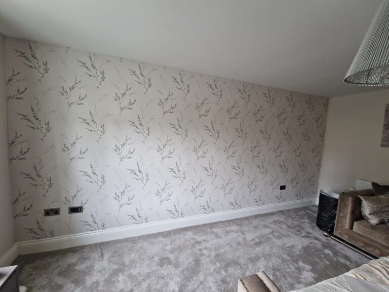 Living room with grey leaf-pattern feature wallpaper