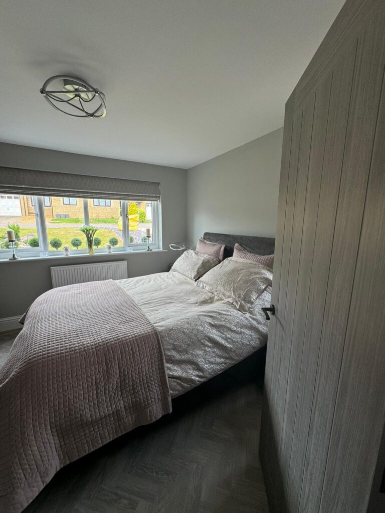 Grey bedroom with panelled wardrobe